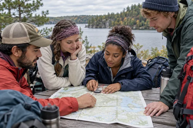 A hand holding a compass outdoors
